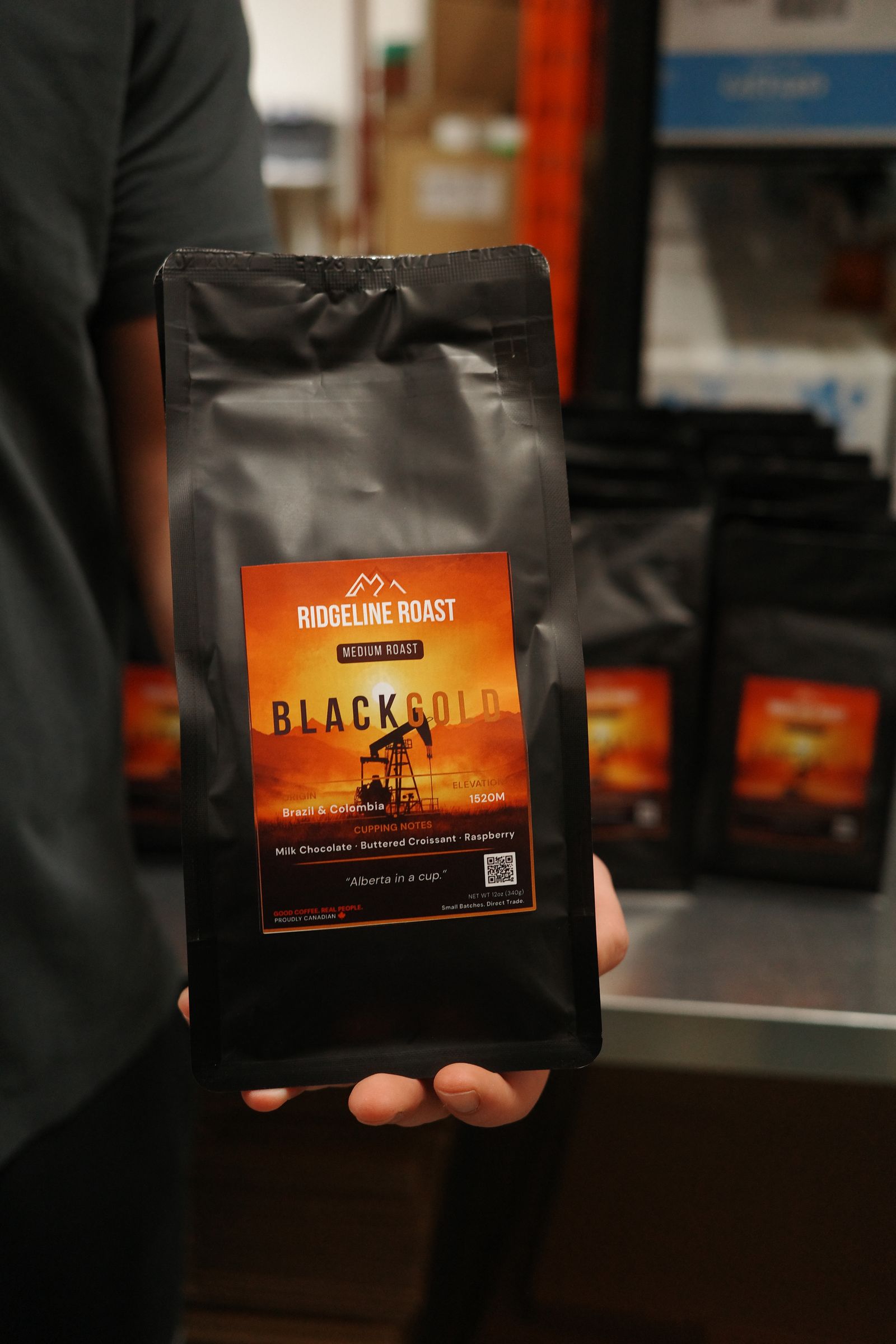 A bag of Black Gold held up in the warehouse