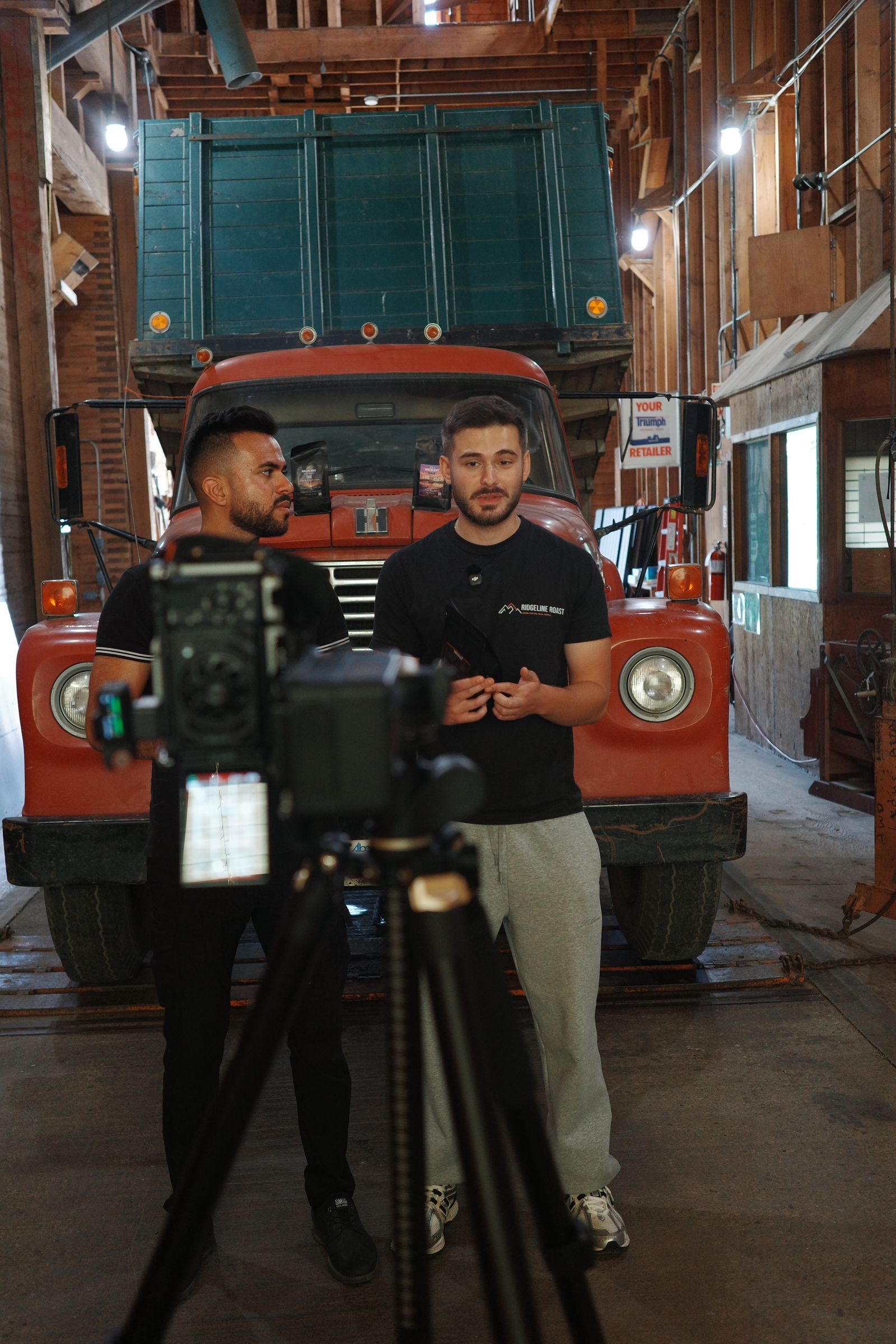 Recording in front of a vintage red truck