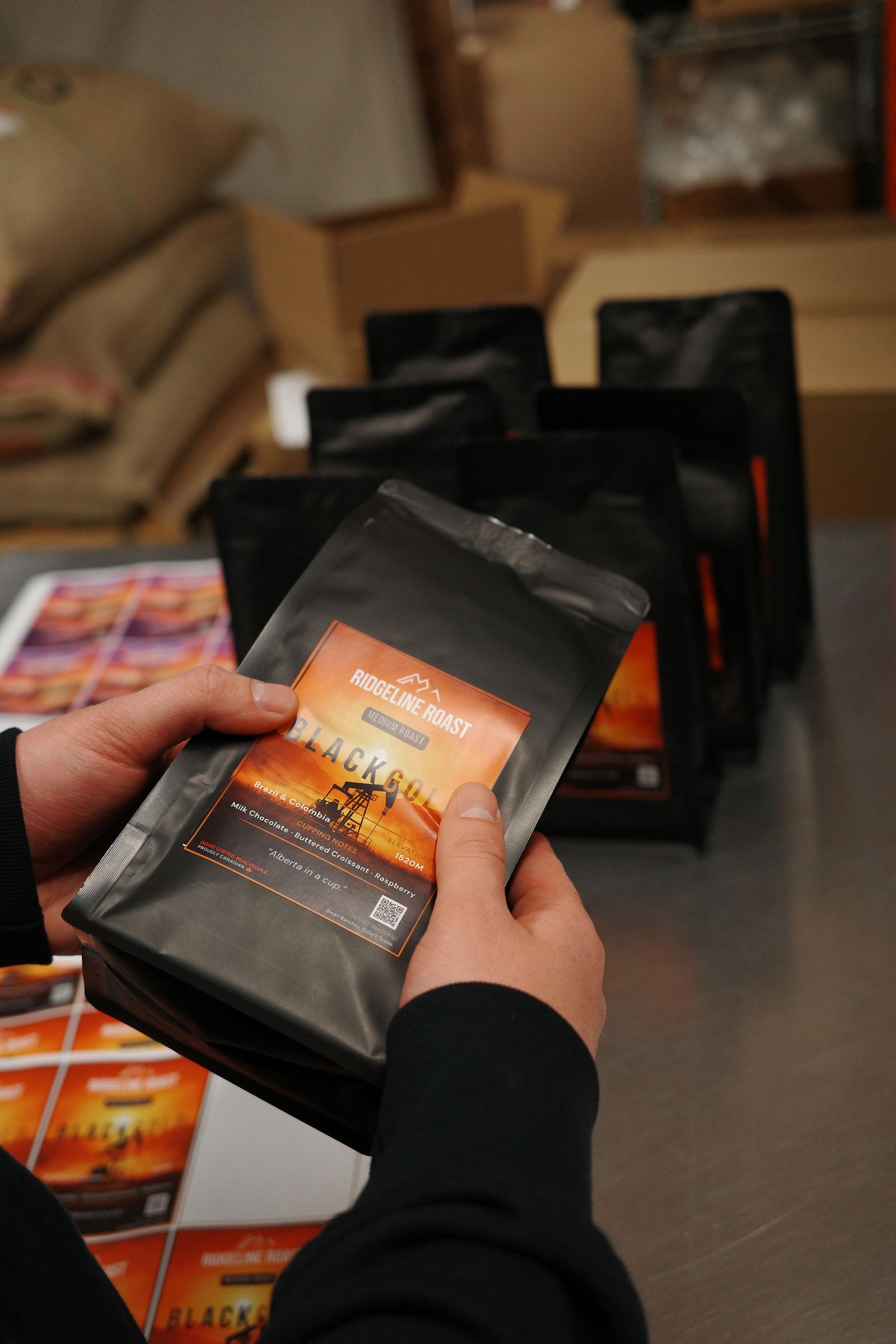Hands holding a bag of Black Gold